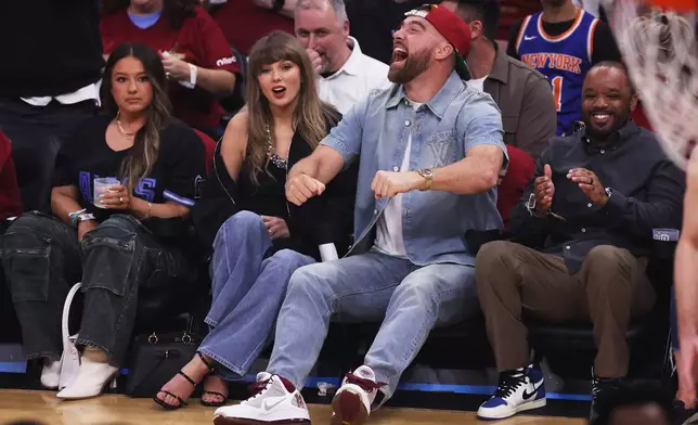 Taylor Swift and Travis Kelce watch the first half of Game 3 in the Eastern Conference finals NBA basketball playoffs series between the New York Knicks and the Cleveland Cavaliers in Cleveland, Saturday, May 23, 2026. (AP Photo/Tim Phillis)