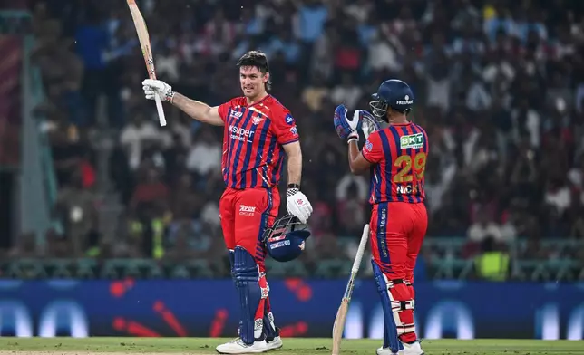 Lucknow Super Giants' Mitchell Marsh, left, celebrates his century with his batting partner Nicholas Pooran during the Indian Premier League cricket match between Royal Challengers Bengaluru and Lucknow Super Giants in Lucknow, India, Thursday, May 7, 2026. (AP Photo)