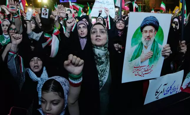 Pro-government demonstrators chant slogans as one of them holds a poster of the Iranian Supreme Leader Ayatollah Mojtaba Khamenei during their gathering at Enqelab-e-Eslami, or Islamic Revolution, square in Tehran, Iran, Monday, May 4, 2026. (AP Photo/Vahid Salemi)