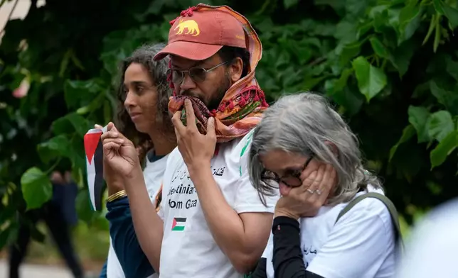 A group of Palestinians gather in front of the main entrance wearing the names of artists who have been killed in Gaza, at the Venice 2026 Biennale Art, Italy, Tuesday, May 5, 2026. (AP Photo/Luca Bruno)