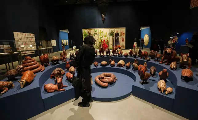 Visitors look at the sculptures inside the main pavilion at the Venice 2026 Biennale Art, in Venice, Italy, Tuesday, May 5, 2026. (AP Photo/Luca Bruno)