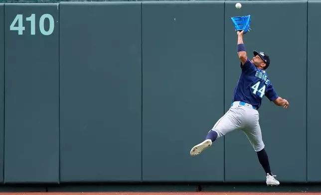 Seattle Mariners center fielder Julio Rodriguez catches a fly ball for the out on Kansas City Royals' Bobby Witt Jr. during the fifth inning of a baseball game Saturday, May 23, 2026, in Kansas City, Mo. (AP Photo/Charlie Riedel)