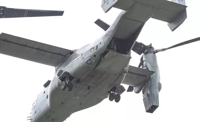 A soldier looks down from a military aircraft as the U.S. Embassy holds an emergency and air evacuation drill in Caracas, Venezuela, Saturday, May 23, 2026. (AP Photo/Pedro Mattey)