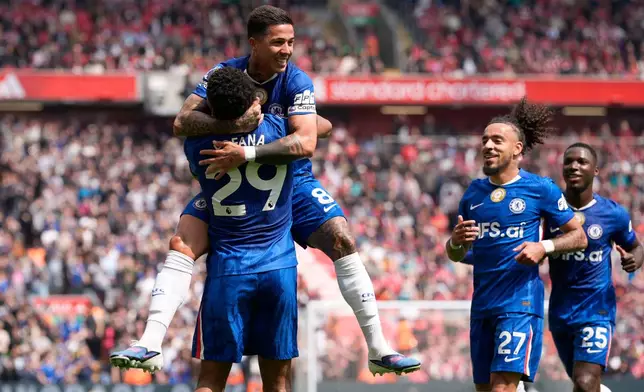 Chelsea's Enzo Fernandez (top) celebrates with team-mate Wesley Fofana after scoring their side's first goal of the game during the Premier League soccer match between Liverpool and Chelsea in Liverpool, England, Saturday, May 9, 2026. (Peter Byrne/PA via AP)