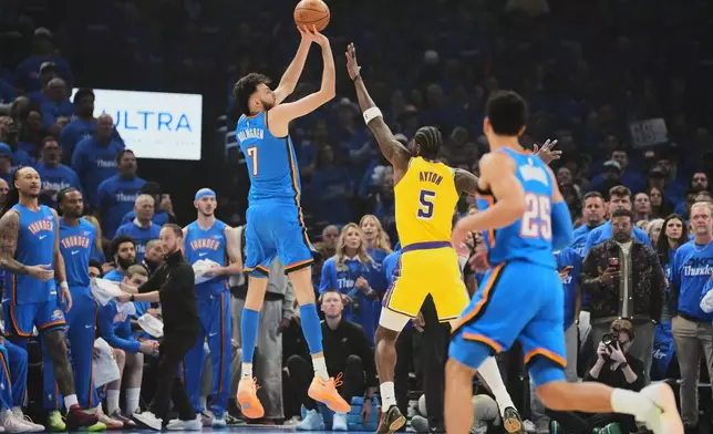 Oklahoma City Thunder center Chet Holmgren (7) shoots over Los Angeles Lakers center Deandre Ayton (5) as Ajay Mitchell (25) looks on in the first half of Game 1 in a second-round NBA basketball playoffs series Tuesday, May 5, 2026 in Oklahoma City. (AP Photo/Kyle Phillips)