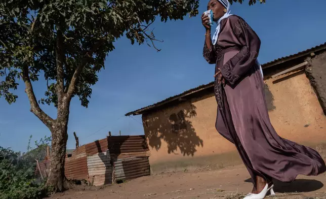 A Muslim woman walks towards the prayer grounds at Sayo Muhamed School to perform Eid al-Adha prayers amid an Ebola outbreak in Bunia, Congo, Wednesday, May 27, 2026. (AP Photo/Moses Sawasawa)