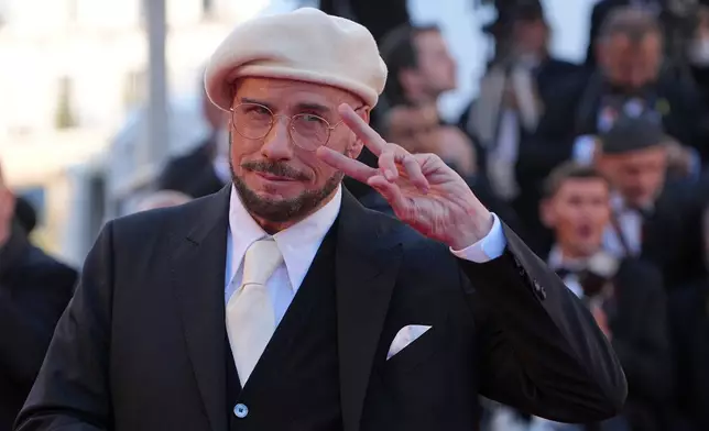 John Travolta poses for photographers upon arrival at the premiere of the film 'Karma' at the 79th international film festival, Cannes, southern France, Friday, May 15, 2026. (AP Photo/Andreea Alexandru)