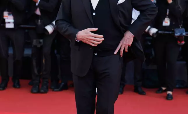 John Travolta poses for photographers upon arrival at the premiere of the film 'Karma' at the 79th international film festival, Cannes, southern France, Friday, May 15, 2026. (Photo by Millie Turner/Invision/AP)