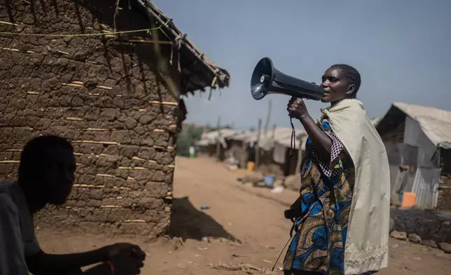 Machozi Naumi, 45, raises awareness of Ebola in the camp on the property of the city's ISP (Institut Supérieur Pédagogique), where internally displaced people reside in Bunia, Congo, Tuesday, May 26, 2026. (AP Photo/Moses Sawasawa)