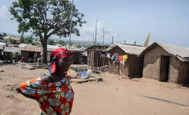 A woman walks in the camp on the property of the city's ISP (Institut Supérieur Pédagogique) where internally displaced people reside in Bunia, Congo, Tuesday, May 26, 2026. (AP Photo/Moses Sawasawa)