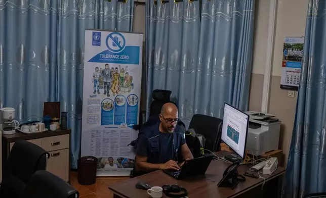 Olivier Nkakudulu, Country Director of the World Food Programme (WFP) in Ituri province, works in his office in Bunia, Congo, Monday, May 25, 2026. (AP Photo/Moses Sawasawa)