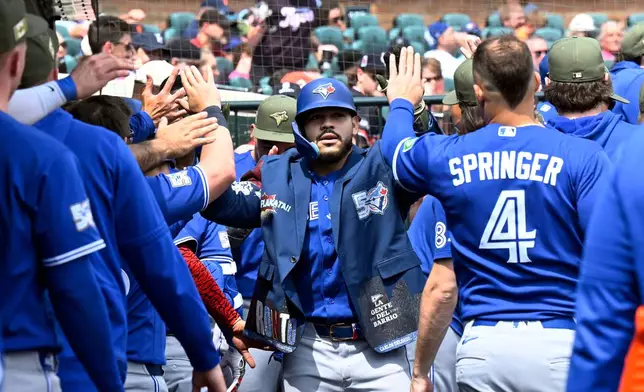 Toronto Blue Jays' Yohendrick Piñango, center, is congratulated in the dugout after hitting a home run during the seventh inning of a baseball game against the Detroit Tigers, Saturday, May 16, 2026, in Detroit. (AP Photo/Jose Juarez)