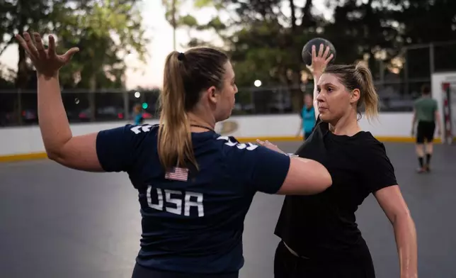 Jillana Darby Lee, right, works with coach Elizabeth Hartnett Wyatt during a handball training session in Tustin, Calif., Wednesday, March 25, 2026. (AP Photo/Jae C. Hong)