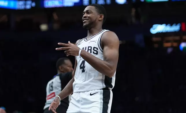 San Antonio Spurs guard De'aaron Fox (4) reacts after scoring against the Minnesota Timberwolves during the second half of Game 6 of an NBA basketball second-round playoffs series in Minneapolis, Friday, May 15, 2026. (AP Photo/Abbie Parr)