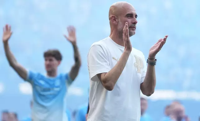 Manchester City's head coach Pep Guardiola applauds the fans after the last fgame with the club after a Premier League soccer match between Manchester City and Aston Villa in Manchester, England, Sunday, May 24, 2026. (AP Photo/Alastair Grant)