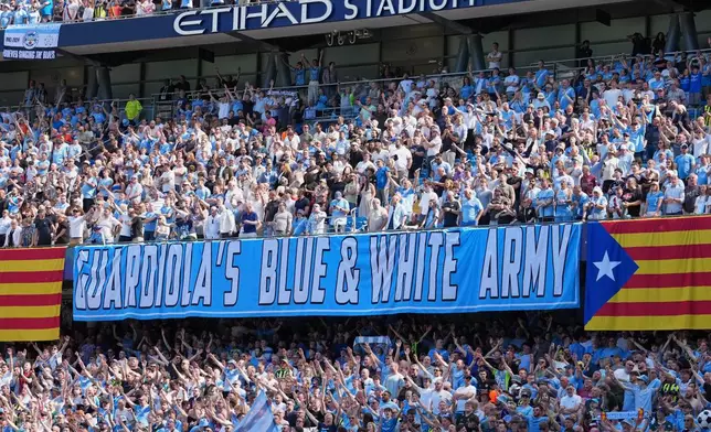 Manchester City fans holds a sign thanking the coach Pep Guardiola during his last macth as a manager during a Premier League soccer match between Manchester City and Aston Villa in Manchester, England, Sunday, May 24, 2026. (AP Photo/Alastair Grant)