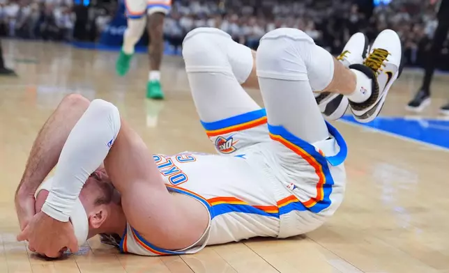Oklahoma City Thunder guard Alex Caruso (9) lies wounded after a fall against the San Antonio Spurs in the first half of Game 5 in the Western Conference finals NBA basketball playoffs series, Tuesday, May 26, 2026, in Oklahoma City. (AP Photo/Julio Cortez)