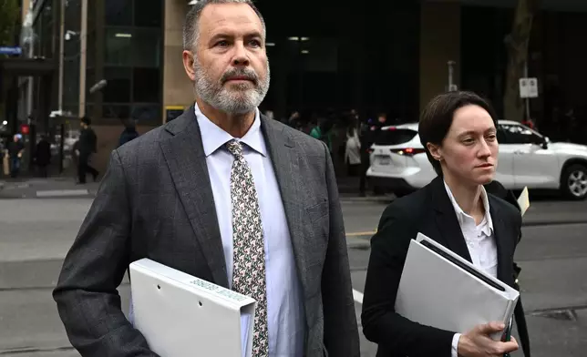 Lawyers Bill Doogue, left, representing Kawsar Abbas, and Maya George, representing Zeinab Ahmed, leave the Melbourne Magistrates' Court in Melbourne, Australia Friday, May 8, 2026, after Abbas and Ahmed were charged with slavery and terrorism offenses after they arrived home from Syria. (Joel Carrett/AAP Image via AP)