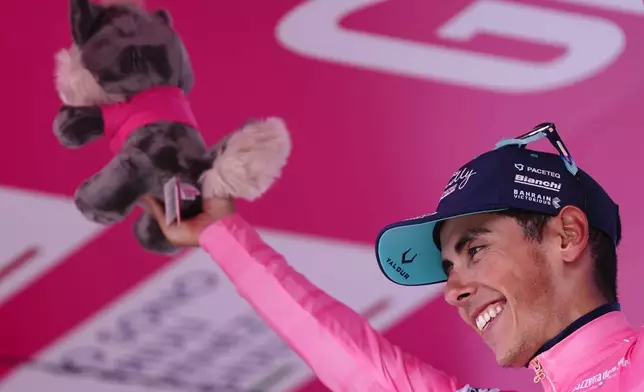 Portugal's Afonso Oliveira Eulalio wears the pink jersey of the race overall leader as he stands on the podium after completing the 10th stage of the Giro d'Italia cycling race from Viareggio to Massa, Italy, Tuesday May 19, 2026. (Fabi Ferrari/LaPresse via AP)