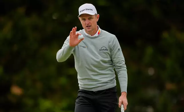 Justin Rose, of England, waves after his putt on the 12th green during the second round of the PGA Championship golf tournament at Aronimink Golf Club, Friday, May 15, 2026, in Newtown Square, PA. (AP Photo/Carolyn Kaster)