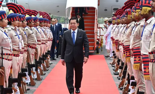 In this photo provided by Myanmar Military True News Information Team on Saturday, May 30, 2026, Myanmar President Min Aung Hlaing, center, inspects guard of honors upon arrival at Gaya airport, near Bodh Gaya, India on May 30. (Myanmar Military True News Information Team via AP)