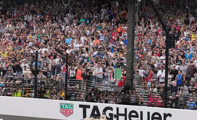 Felix Rosenqvist, top, of Sweden, beats David Malukas, bottom, to the finish line to win the Indianapolis 500 auto race at Indianapolis Motor Speedway in Indianapolis, Sunday, May 24, 2026. (AP Photo/Michael Conroy)