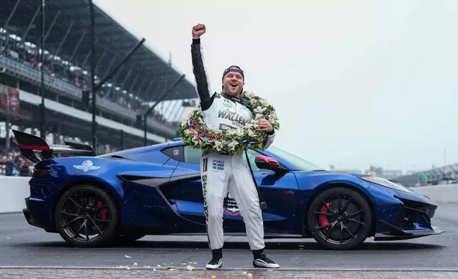Felix Rosenqvist, of Sweden, pumps his fist at the request of track officials after winning the Indianapolis 500 auto race at Indianapolis Motor Speedway, Sunday, May 24, 2026 in Indianapolis. (AP Photo/AJ Mast)