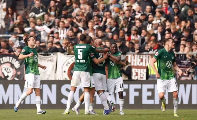 Wolfsburg's players celebrate after their second goal during the German Bundesliga soccer match between FC St. Pauli and VfL Wolfsburg in Hamburg, Germany, Saturday, May 16, 2026. (Christian Charisius/dpa via AP)