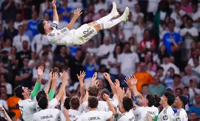 Real Madrid's players throw Dani Carvajal after playing the last game for the club after a La Liga soccer match between Real Madrid and Athletic in Madrid, Spain, Saturday, May 23, 2026. (AP Photo/Manu Fernandez)