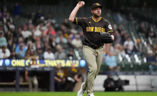 San Diego Padres' Michael King throws to first base during the fifth inning of a baseball game against the Milwaukee Brewers, Wednesday, May 13, 2026, in Milwaukee. (AP Photo/Aaron Gash)