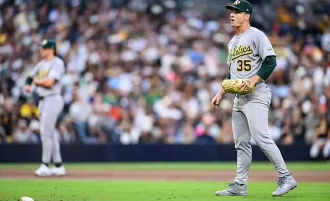Athletics pitcher J.T. Ginn (35) looks on after giving up three walks in a row during the second inning of a baseball game against the San Diego Padres, Saturday, May 23, 2026, in San Diego. (AP Photo/William Liang)