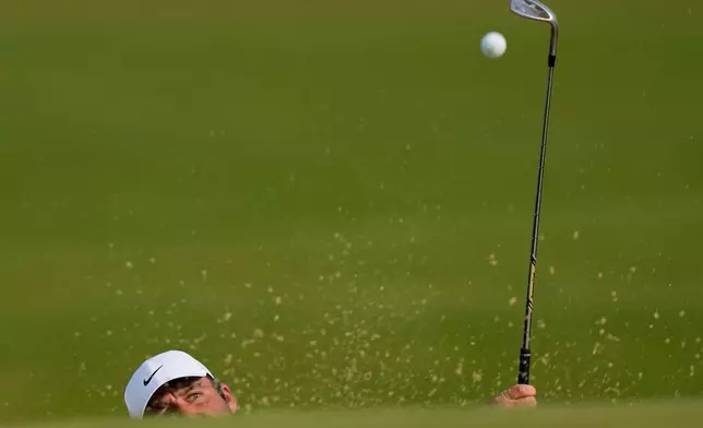 Scottie Scheffler hits out of the bunker on the 16th green during the third round of the PGA Championship golf tournament at Aronimink Golf Club, Saturday, May 16, 2026, in Newtown Square, PA. (AP Photo/Matt Slocum)