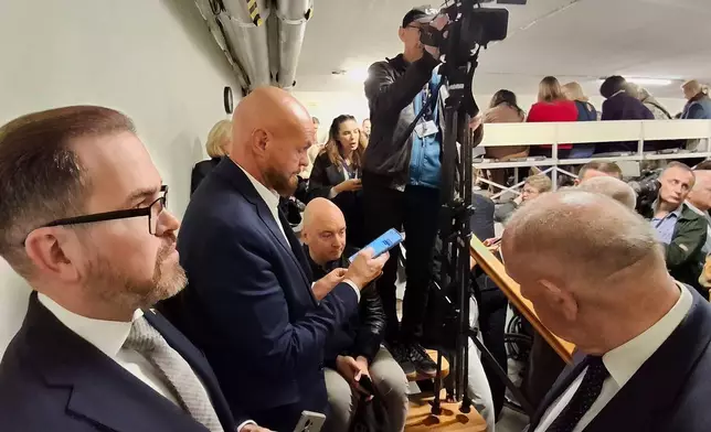 Following an air raid alert members of parliament and media representatives gather in a shelter at the parliament building in Vilnius, Lithuania, Wednesday, May 20, 2026. (Zygimantas Pavilionis via AP)