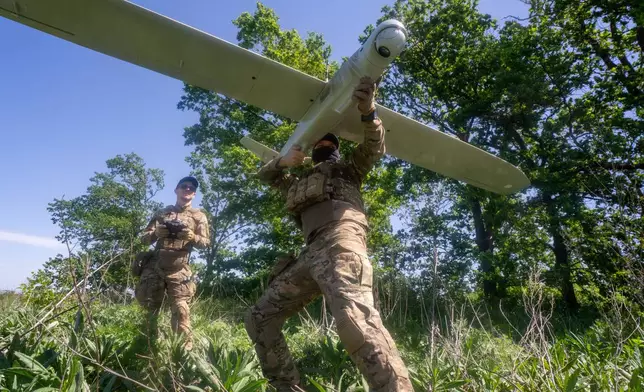 Ukrainian servicemen of Khartia brigade launch a drone towards Russian positions at the front line in the Kharkiv region, Ukraine, Wednesday, May 20, 2026. (AP Photo/Andrii Marienko)