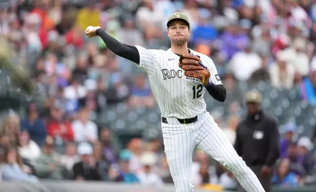 Colorado Rockies third baseman Kyle Karros throws the ball to first base after fielding an RBI single off the bat of Arizona Diamondbacks' Jose Fernandez in the fifth inning of a baseball game Sunday, May 17, 2026, in Denver. (AP Photo/David Zalubowski)