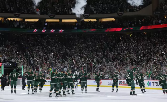 Minnesota Wild players celebrate after wining Game 6 in the first round of the NHL hockey Stanley Cup playoff series against the Dallas Stars, Thursday, April 30, 2026, in St. Paul, Minn. (AP Photo/Bailey Hillesheim)