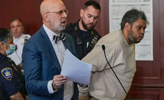 Randy Santos, right, and his attorney Arnold Levine appear in court after he was sentenced for fatally beating four sleeping men on the streets in 2019, in New York, Thursday, May 28, 2026. (AP Photo/Richard Drew)