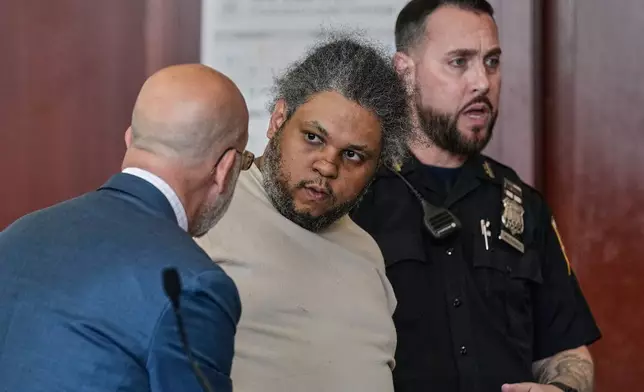 Randy Santos, right, listens to his attorney Arnold Levine in court after he was sentenced for fatally beating four sleeping men on the streets in 2019, in New York, Thursday, May 28, 2026. (AP Photo/Richard Drew)