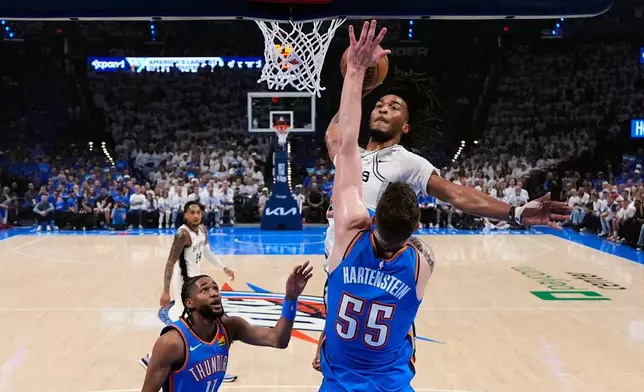 San Antonio Spurs guard Stephon Castle (5) dunks against Oklahoma City Thunder center Isaiah Hartenstein (55) during the first half of Game 2 in the Western Conference finals NBA basketball playoffs series Wednesday, May 20, 2026, in Oklahoma City. (AP Photo/Nate Billings)