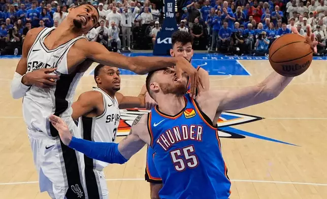 San Antonio Spurs forward Victor Wembanyama (1) defends against Oklahoma City Thunder center Isaiah Hartenstein (55) during the second half of Game 2 in the Western Conference finals NBA basketball playoffs series Wednesday, May 20, 2026, in Oklahoma City. (AP Photo/Nate Billings)