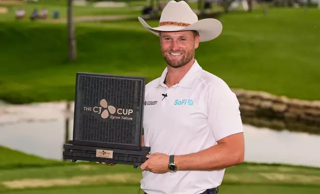 Wyndham Clark poses for photos after winning the CJ Cup Byron Nelson golf tournament in McKinney, Texas, Sunday, May 24, 2026. (AP Photo/Tony Gutierrez)