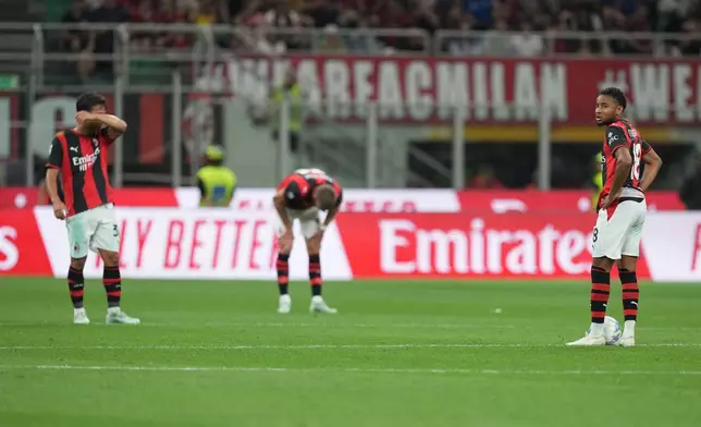 AC Milan's Christopher Nkunku, right, reacts with his teammates after Cagliari's Juan Rodriguez scored his side's second goal during the Serie A soccer match between AC Milan and Cagliari, in Milan, Italy, Sunday, May 24, 2026. (AP Photo/Antonio Calanni)