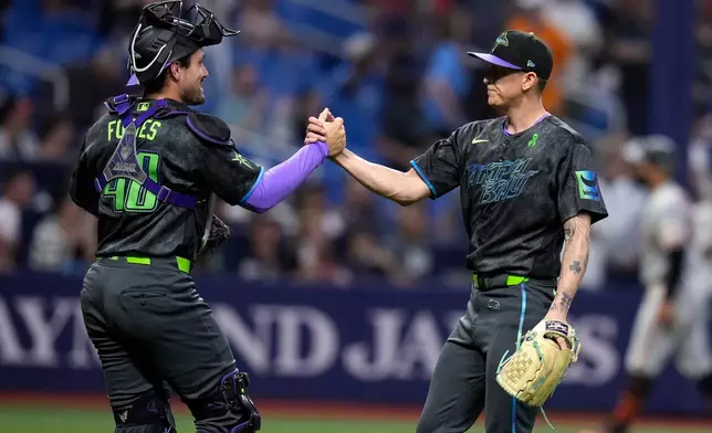 Tampa Bay Rays pitcher Casey Legumina, right, celebrates with catcher Nick Fortes after closing out the San Francisco Giants during a baseball game Saturday, May 2, 2026, in St. Petersburg, Fla. (AP Photo/Chris O'Meara)