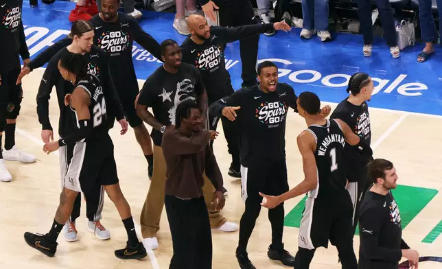 San Antonio Spurs forward Victor Wembanyama (1) celebrates with teammates during the second overtime of Game 1 in a third-round NBA basketball playoffs series against the Oklahoma City Thunder Monday, May 18, 2026, in Oklahoma City. (AP Photo/Nate Billings)