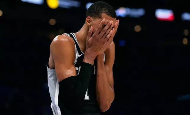San Antonio Spurs forward Victor Wembanyama reacts during the second overtime of Game 1 in a third-round NBA basketball playoffs series against the Oklahoma City Thunder Monday, May 18, 2026, in Oklahoma City. (AP Photo/Tony Gutierrez)