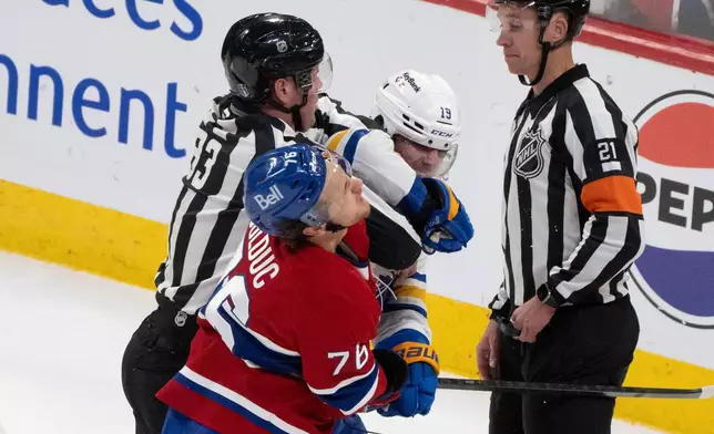 Montreal Canadiens' Zachary Bolduc (76) and Buffalo Sabres' Peyton Krebs (19) fight during the first period in Game 4 of a second-round NHL hockey playoff game in Montreal on Tuesday, May 12, 2026. (Christinne Muschi/The Canadian Press via AP)