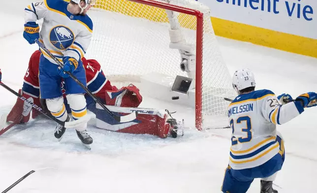 Buffalo Sabres' Mattias Samuelsson (23) scores on Montreal Canadiens goaltender Jakub Dobes (75) as Zach Benson (6) blocks during first period second round, Game 4, NHL playoff game in Montreal on Tuesday, May 12, 2026. (Christinne Muschi/The Canadian Press via AP)