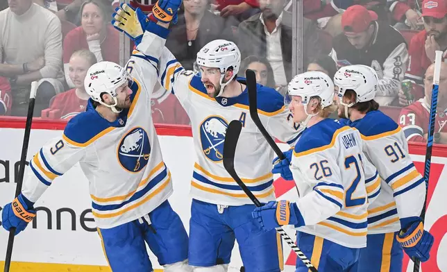 Buffalo Sabres' Mattias Samuelsson (23) celebrates with teammates after scoring against the Montreal Canadiens during the first period in Game 4 of a second-round NHL hockey playoff game in Montreal on Tuesday, May 12, 2026. (Graham Hughes/The Canadian Press via AP)