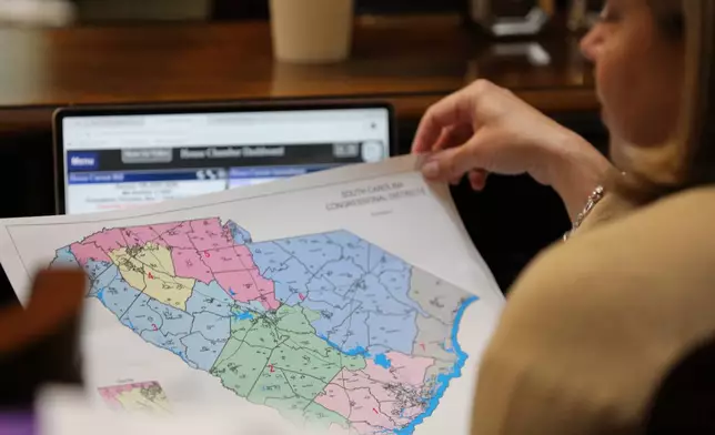 Republican South Carolina Rep. Jackie Terribile looks at a proposed map of new U.S. House districts for South Carolina on Thursday, May 7, 2026, in Columbia, S.C. (AP Photo/Jeffrey Collins)