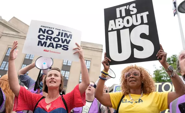 Mandy Cook, left, and Cheryl Woodard, hold signs during a rally against a special session of the state legislature to redraw U.S. Congressional voting maps Tuesday, May 5, 2026, in Nashville, Tenn. (AP Photo/George Walker IV)